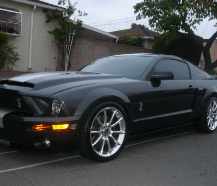 Close-up of a luxury vehicle featuring flawless ceramic window tint under natural light