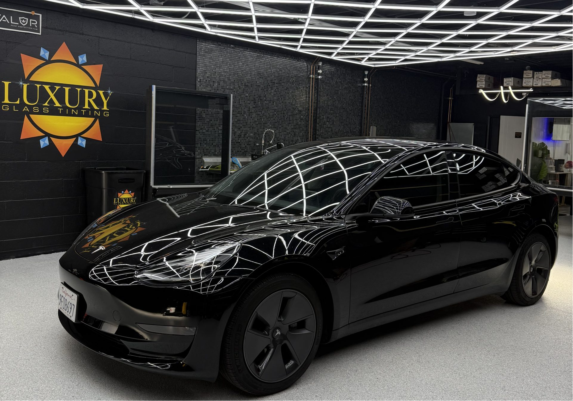 A vehicle with ceramic window tint and clear paint protection film installed