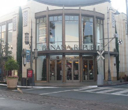 Sunlit façade of a well-known brand store with professionally installed window film