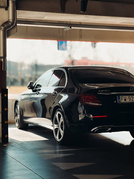 Luxury sedan with ceramic window tint parked in an underground garage.