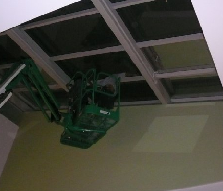 A professional applying solar control film on large commercial windows.