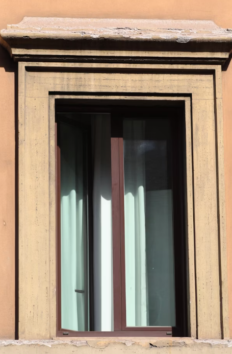 This image shows a glass window in a brown frame.