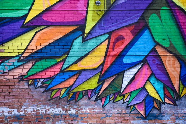 This photo shows a vibrant graffiti covered wall symbolizing property damaged