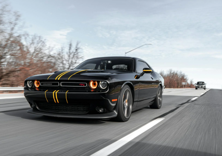 This image shows a black car on an empty road.