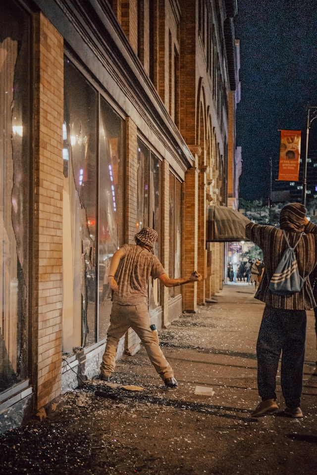 This photo shows individuals defacing a commercial property wall