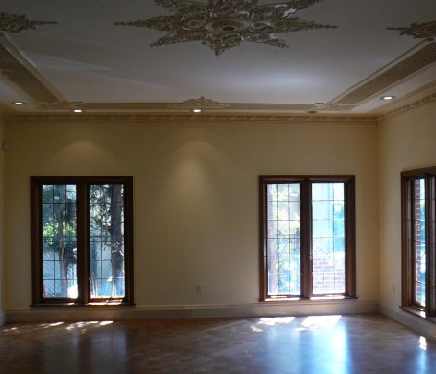 Modern living room with large tinted windows featuring sun-blocking window film