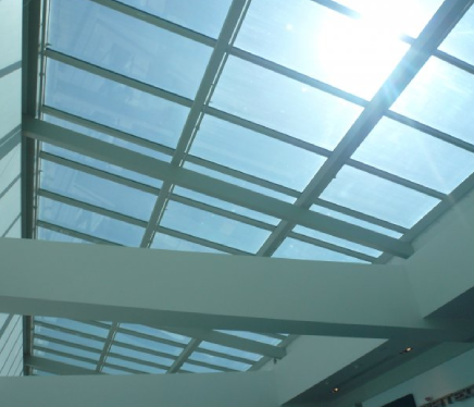 A glass office window treated with commercial window film for improved energy efficiency.