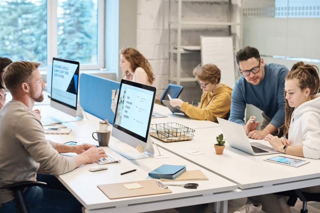 Employees working collaboratively in an open office layout.