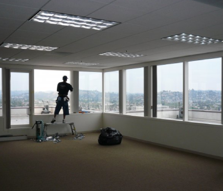 Professional technician installing commercial window film on an office building in Beverly Hills.