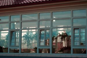 commercial solar control window tinting office windows Commercial building with large glass panels fitted with solar window tint for office windows to reduce heat and glare.