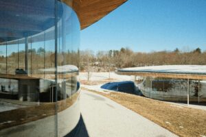 modern office building solar window film glass Modern glass office building with solar window film on curved exterior windows for heat and glare control.