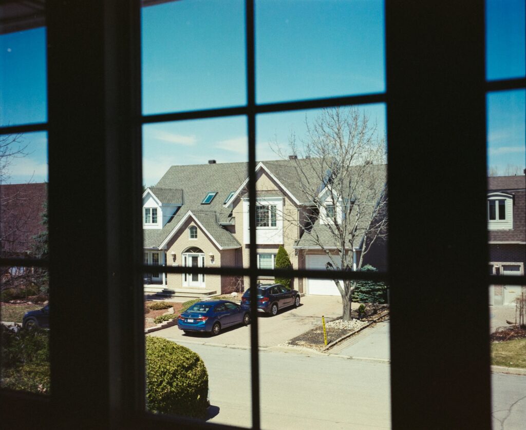 home windows with household window tint looking out onto a quiet residential street.