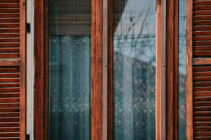 Wood-framed home window with decorative privacy film pattern